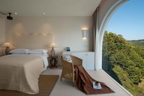 a bedroom with a bed and a large window at Miyue Shenzhen Blue and White Holy Island Cliff Pool Hotel in Shenzhen