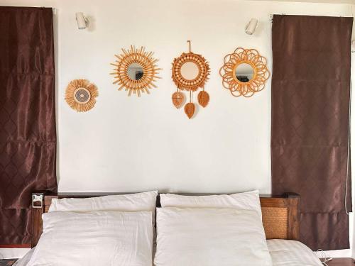 a bedroom with a bed with four mirrors on the wall at Ibiza Bungalows in Haad Yao
