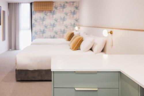 a hotel room with a bed and a white counter at Surfside 22 in Wollongong
