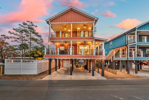 a large house with balconies on a street at Ocean Lakes getaway 6bd with arcade game table in Myrtle Beach