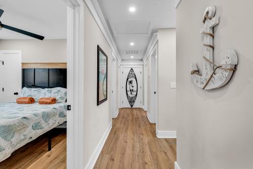 a bedroom with a bed in a white room at Ocean Lakes getaway 6bd with arcade game table in Myrtle Beach