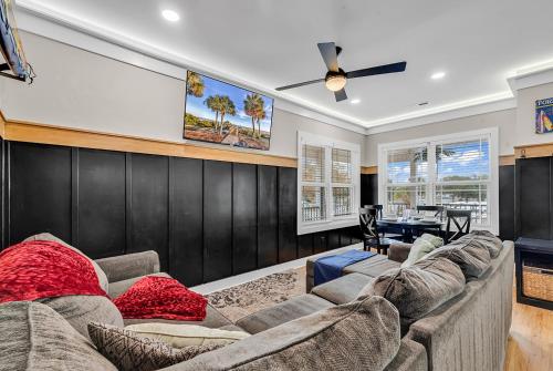 a living room with a couch and a tv at Ocean Lakes getaway 6bd with arcade game table in Myrtle Beach