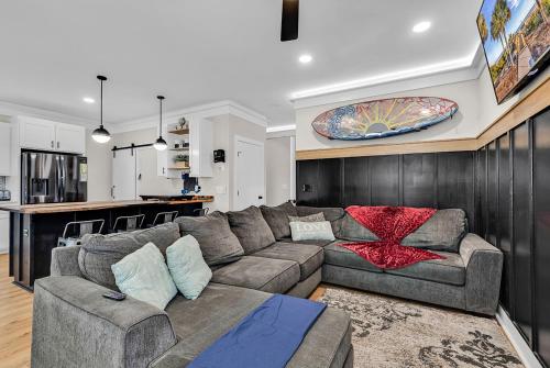 a living room with a couch and a kitchen at Ocean Lakes Walk to beach! Waterpark! Arcade! Dogs Welcome! in Myrtle Beach