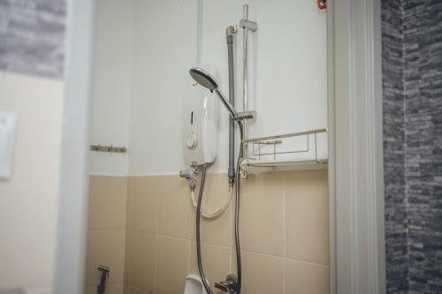 a shower in a bathroom with a toilet at Tun Aminah Shoplot 10-15pax KTV Mahjong Funhouse by Our Stay in Skudai