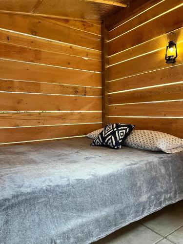 two pillows sitting on a bed in a room at Butterfly Cottage - open air eco villa in Oliver