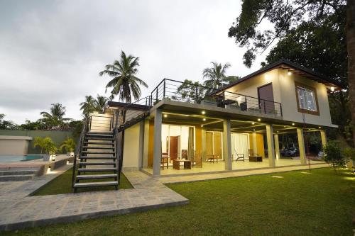 a house with a staircase leading up to it at Lindy Stays Talpe in Pitiduwa