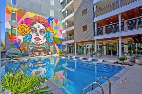a mural on the side of a building with a pool at Top Floor City Views! King Bed Pool Gym Free Parking in San Antonio