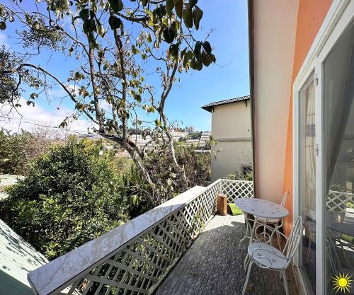 a patio with a table and chairs on a balcony at Otel Hotel Dalat in Da Lat