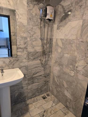 a bathroom with a sink and a shower at 777 Beach Condo Phuket in Mai Khao Beach