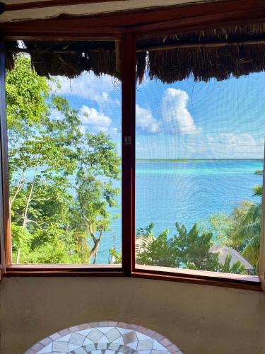 a view of the ocean from a window at Tucán Villages Bacalar Lagoon Front in Bacalar