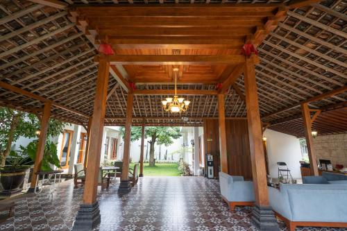 a large wooden pavilion with a chandelier in a room at Kinkeo Borobudur in Magelang