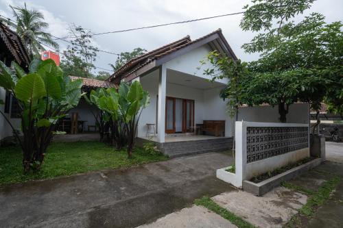 a small white house with a yard at Kinkeo Borobudur in Magelang