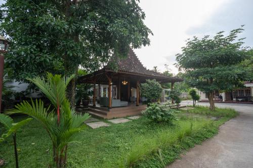 a small house with a porch and a yard at Kinkeo Borobudur in Magelang