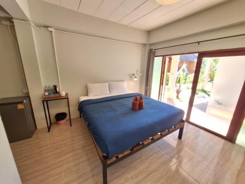 a bedroom with a bed with two shoes on it at Sleep Pai Bed & Breakfast in Pai