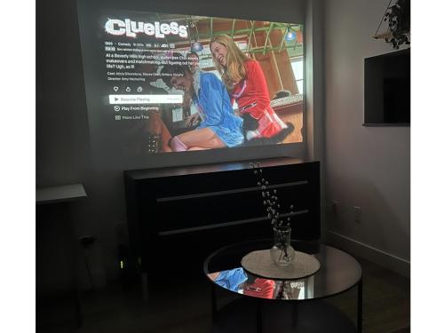 a tv screen above a table in a room at City Retreat With Views in the Heart of Downtown in Vancouver