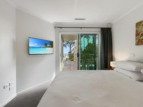 a bedroom with a bed and a view of the ocean at Spacious 4-Bed Home with Coastal Charm in Long Beach