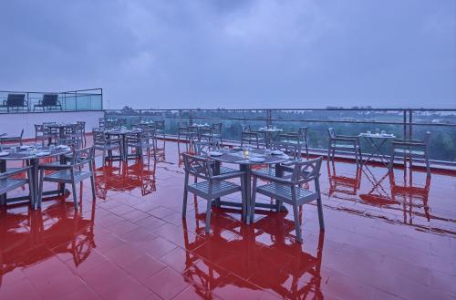 a row of tables and chairs on a roof at Grand Continent Mahabalipuram A Sarovar Premiere Affiliate Hotel in Mahabalipuram