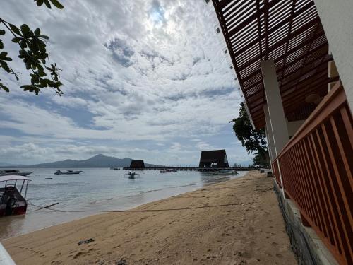 a view of a beach with boats in the water at mc villa bunaken in Bunaken