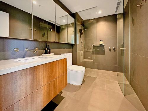 a bathroom with a toilet and a sink and a shower at 1 Bedroom Apartment With Parking Close To Beach in Williamstown
