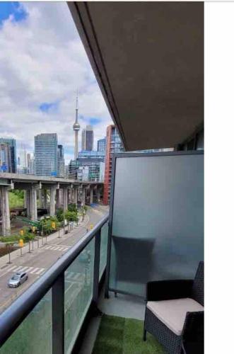 a balcony with a view of a city at Luxury Downtown Condo with CN tower views, Pool Access, Gym,Free Parking upon request at booking, accommodates 4 in Toronto