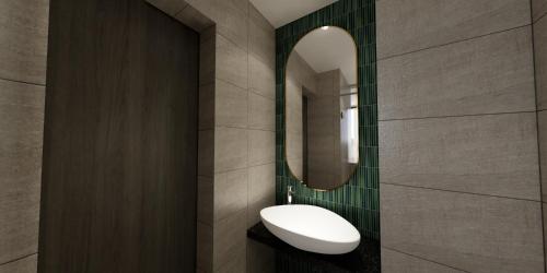 a bathroom with a sink and a mirror at The Explorer Hotel in Melaka