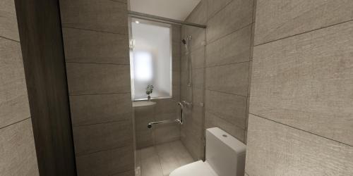 a bathroom with a toilet and a shower with a window at The Explorer Hotel in Melaka