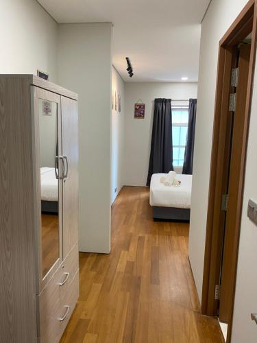a room with a bedroom with a bed and a closet at Chambers KLCC Serviced Suites One in Kuala Lumpur