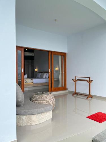a living room with a bed and a couch and a table at Amed Sea Resort in Amed