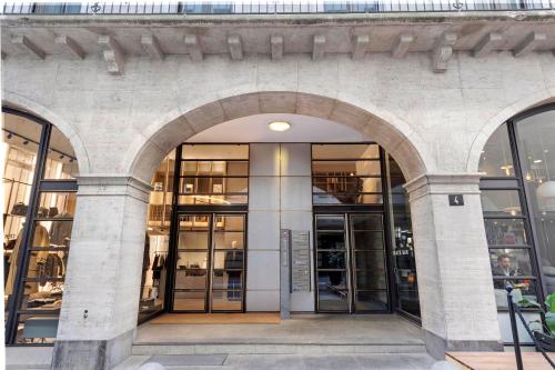 an entrance to a building with large glass doors at Novos Arcadia 501 - Happy Rentals in Lugano