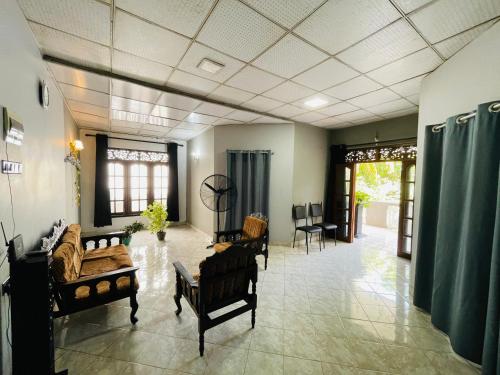 a large living room with couches and chairs at Avartha Centre - Simple & Cozy in Matara