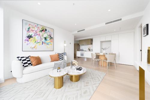 a white living room with a couch and a table at Top CBD Skyline Luxury Apartments 2 Beds or 3 Beds, 2 Baths, Free Parking in Melbourne