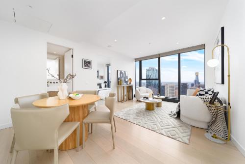 a dining room and living room with a table and chairs at Top CBD Skyline Luxury Apartments 2 Beds or 3 Beds, 2 Baths, Free Parking in Melbourne