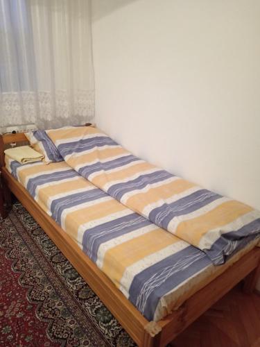 a bed sitting in a corner of a room at Etno kutak Jaćimović in Gornji Milanovac