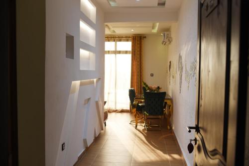 a hallway with a table and a painting on the wall at Résidence Le Sommet Douala in Douala
