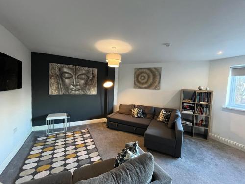 a living room with a couch and a table at Mia's Place Three Apartments in One in Chester