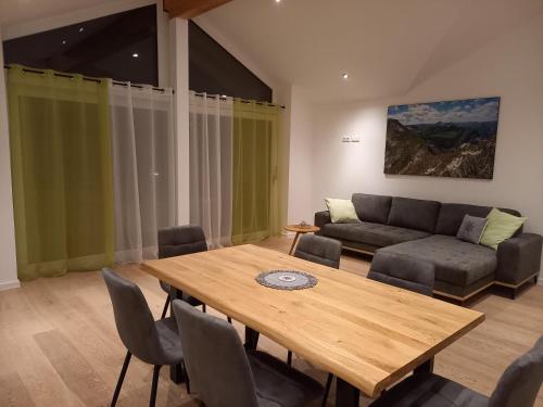 a living room with a wooden table and a couch at Bergzauber Ofterschwang in Ofterschwang