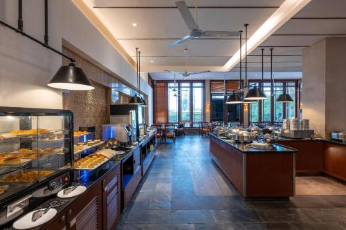 a restaurant with a buffet line with food on display at Tianhong Resort Hotel, Yalong Bay, Sanya in Sanya