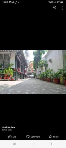a picture of a street with plants on the side at Hotel Ashiana in Siliguri