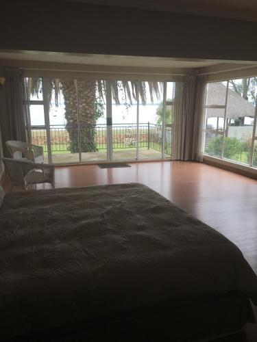 a bedroom with a bed and a large window at Danica's in Denysville