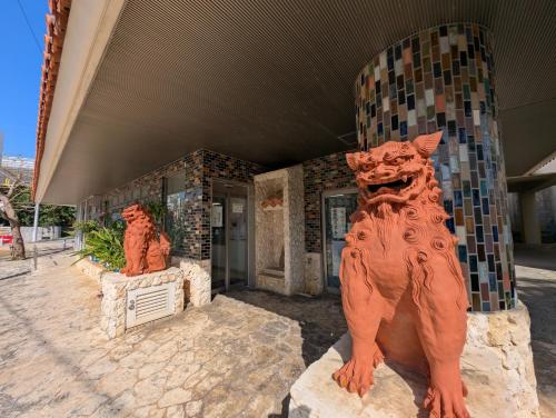 two statues of lions in front of a building at 那覇ワンツボ国際通りから徒歩圏内Okinawa Naha Main Street Walking in Naha