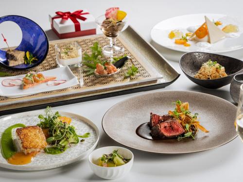 a table topped with plates of food and dishes at Tokyo Bay Shiomi Prince Hotel in Tokyo