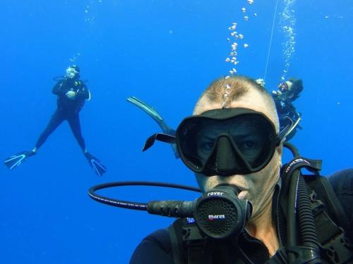 a man in a diver mask and people in the water at Little Santorini Retreat - Family Home near Theme Parks in Pimpama