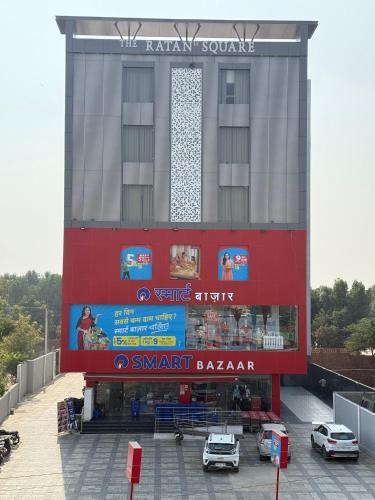 a large building with cars parked in front of it at Hotel Ratan Elite in Bijainagar