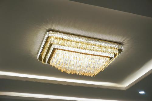 a chandelier hanging from the ceiling of a room at Hotel Ratan Elite in Bijainagar