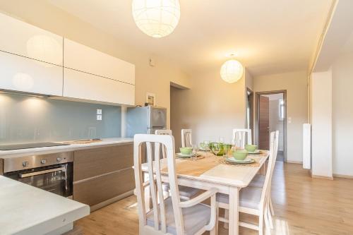 a kitchen and dining room with a table and chairs at Chania Urban Living - Live like a local in Chania Town