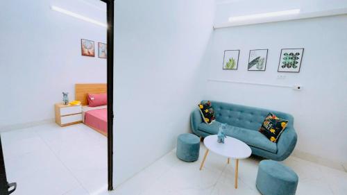 a living room with a blue couch and a table at 46 An Hòa, Mỗ lao in Hanoi