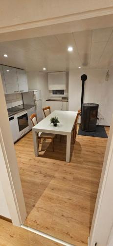 a kitchen with a white table in a room at Airolo with private parking in Airolo