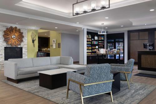 a living room with a couch and a table and chairs at Homewood Suites by Hilton Waterloo/St. Jacobs in Waterloo