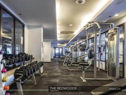 a gym with rows of treadmills and machines at The Redwoods SM Fairview with Balcony in Manila