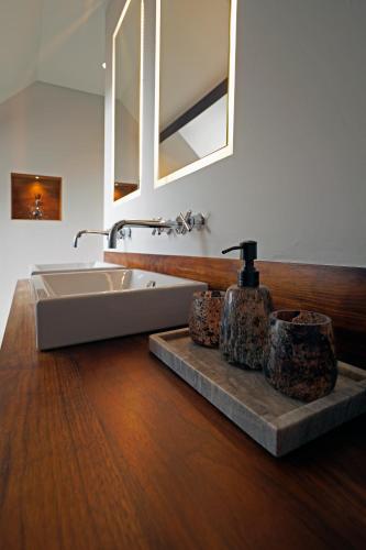 a bathroom with a sink and a mirror at B&B Het Havenhuis in Bruges